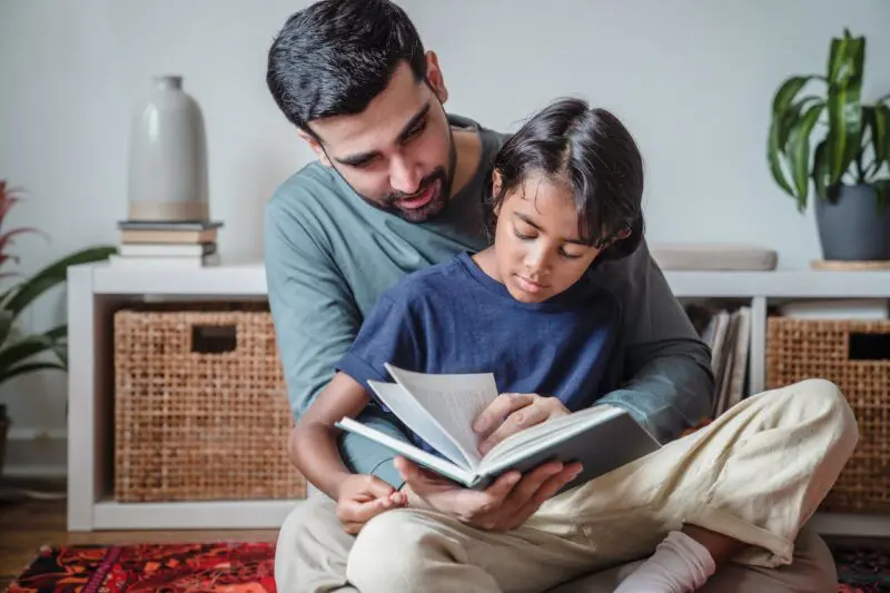 Father and son reading in the living room