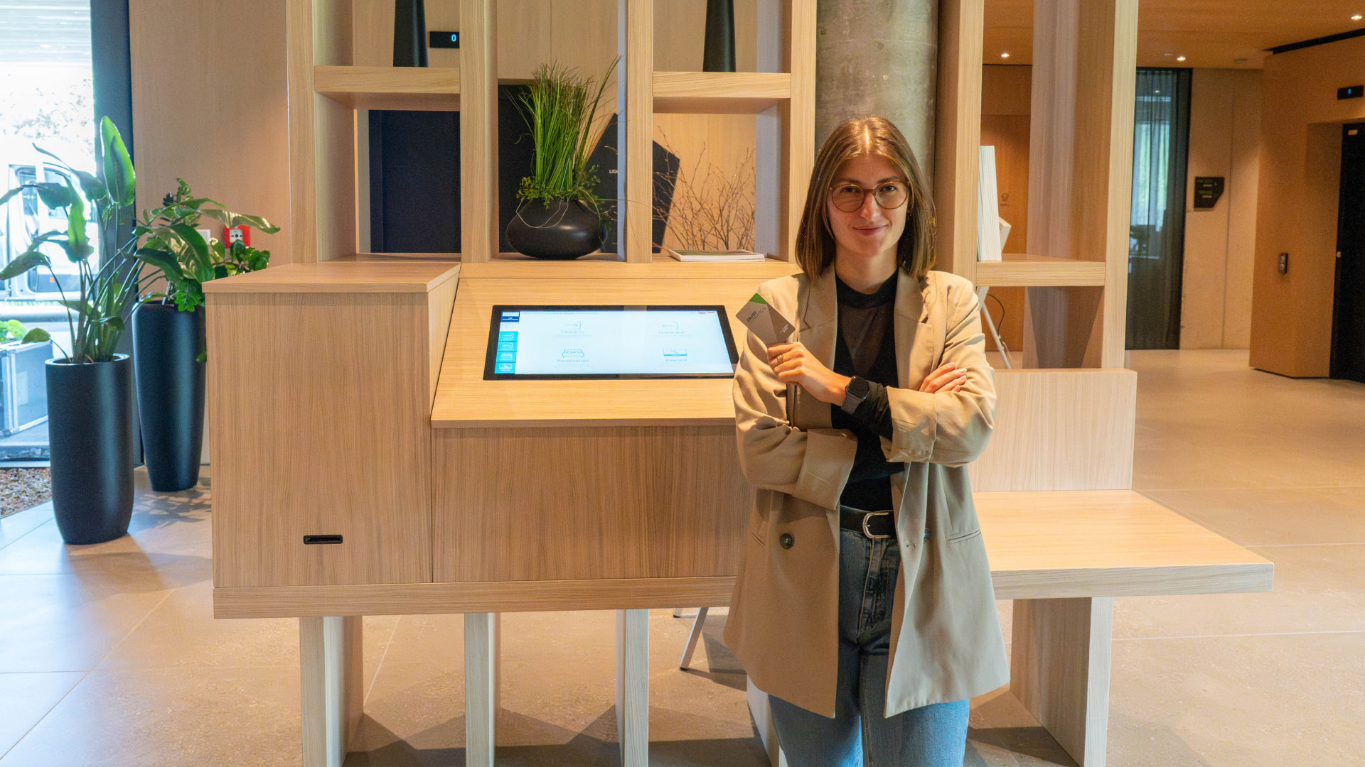 Women stood at self check-in desk at Loxone Campus